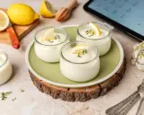 Delicioso mousse de limón Thermomix en vasitos, decorado con rodajas de limón y tomillo. Frescura y sabor en cada cucharada.