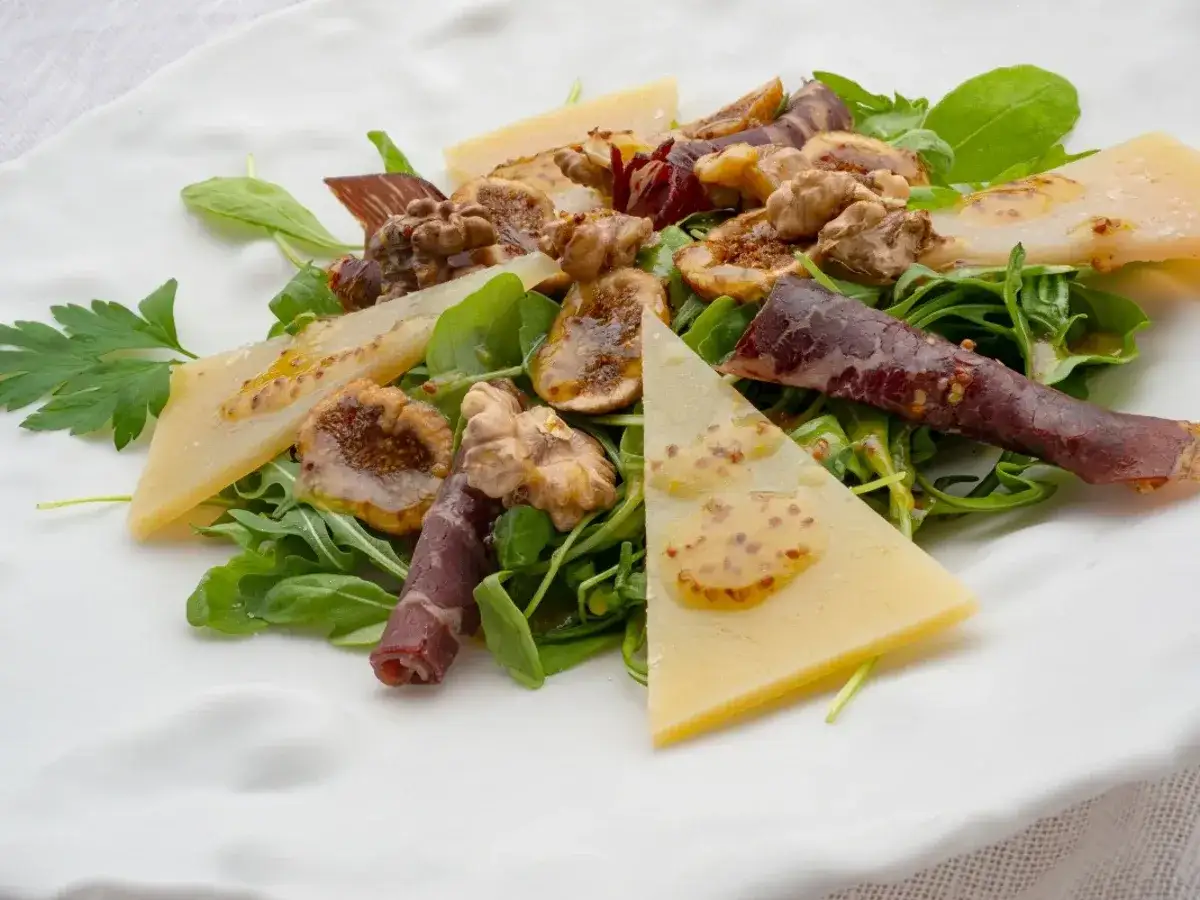 Deliciosa ensalada de cecina con higos, nueces, queso y aderezo de mostaza sobre r&uacute;cula fresca.