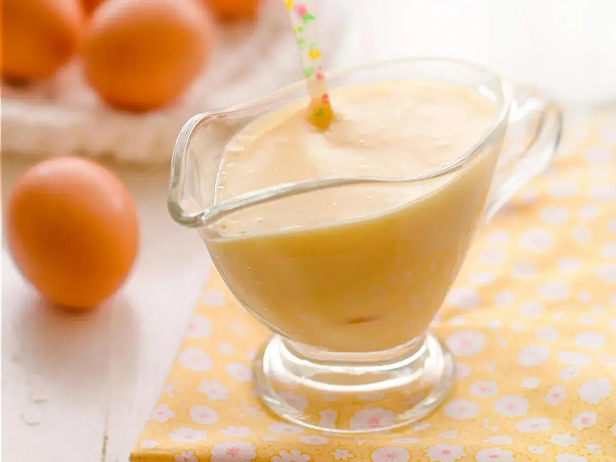 Crema pastelera suave y sedosa, lista para usar. Huevos frescos y una pajita decorada sugieren una preparaci&oacute;n f&aacute;cil con Thermomix.